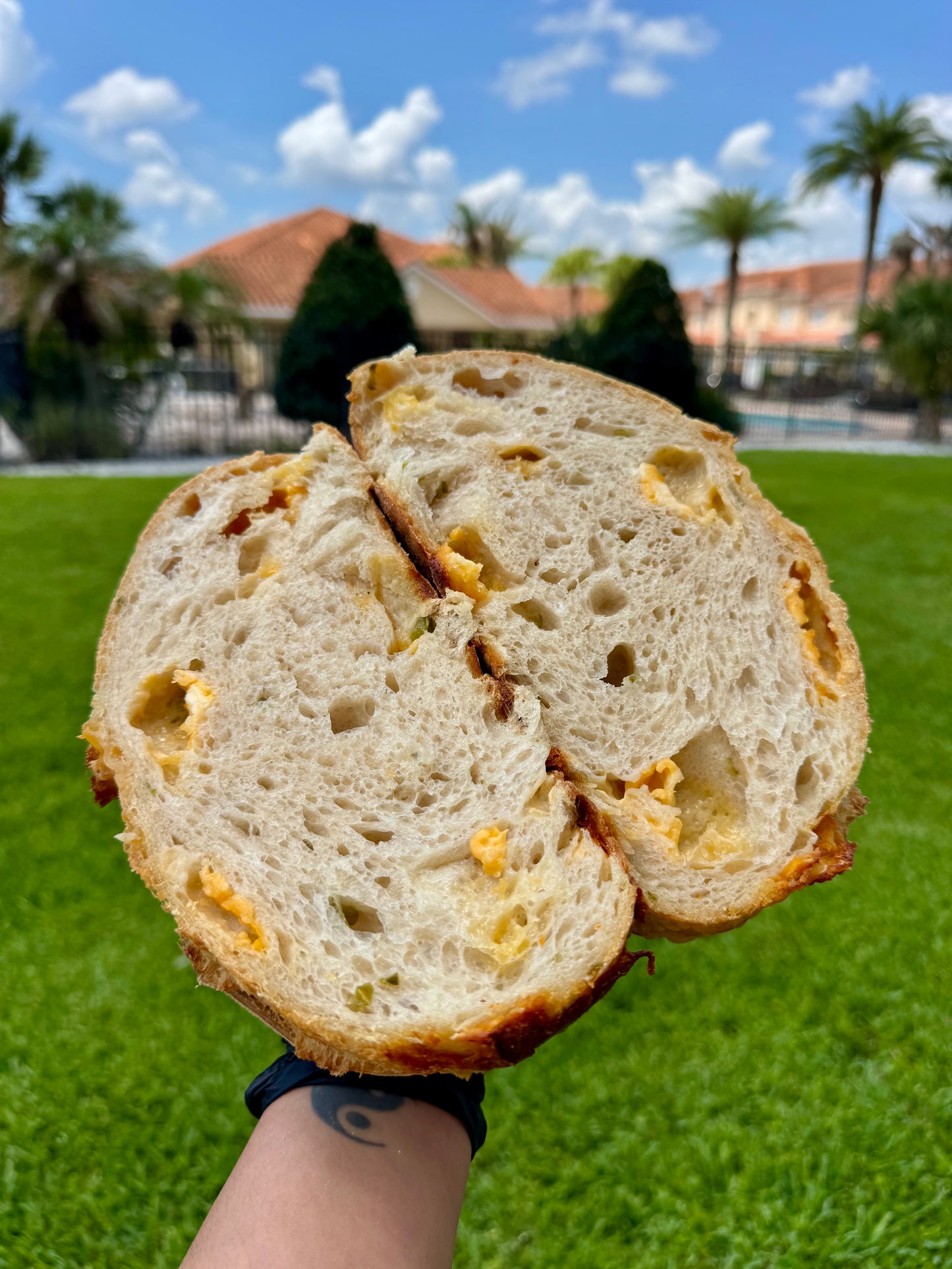 Fresh organic cheddar and jalapeño sourdough loaf made with sharp cheddar cheese, fresh jalapeños, and naturally fermented sourdough starter, handcrafted by The Blissful Bakehouse.